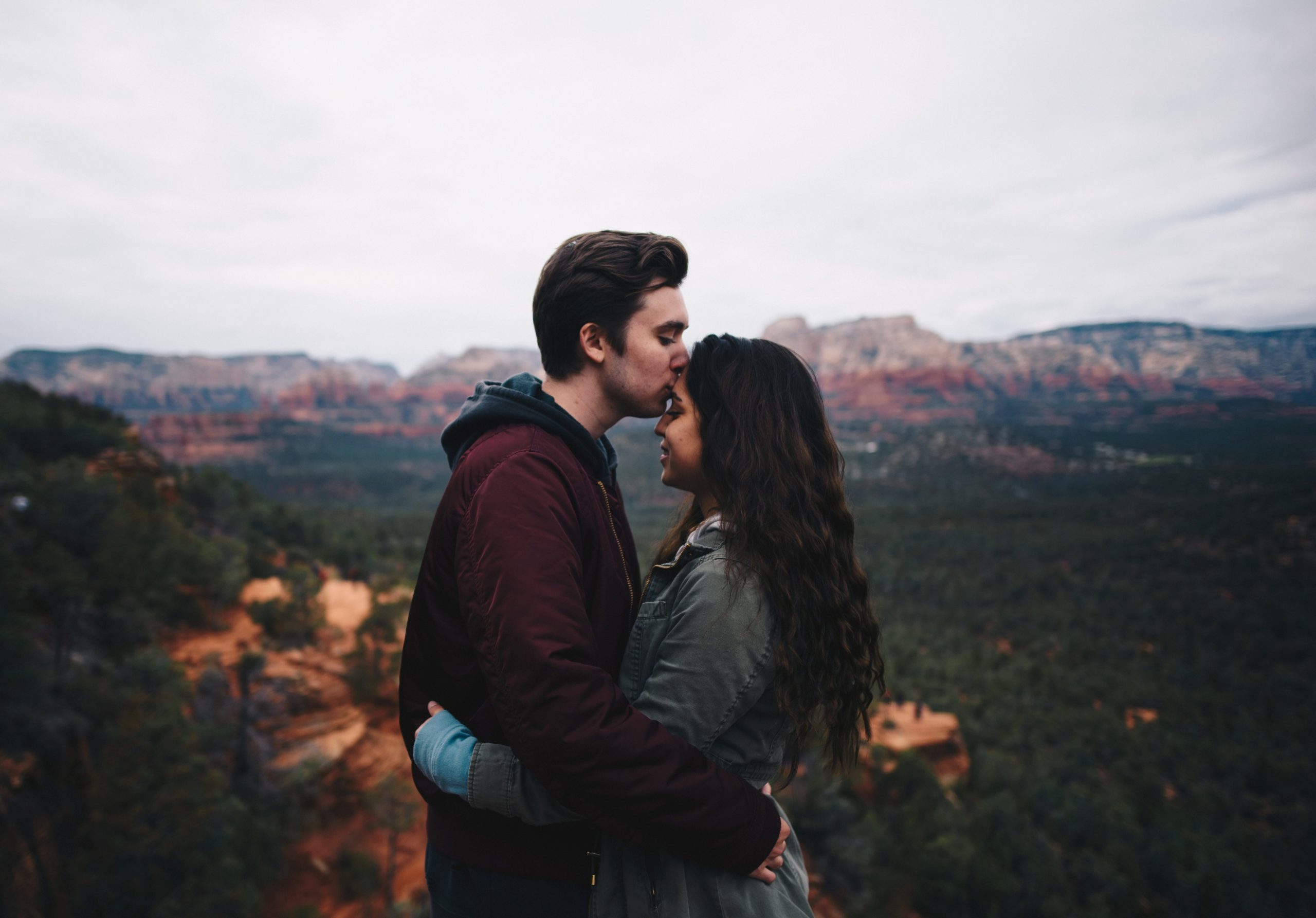man kissing woman's forehead - relationship
